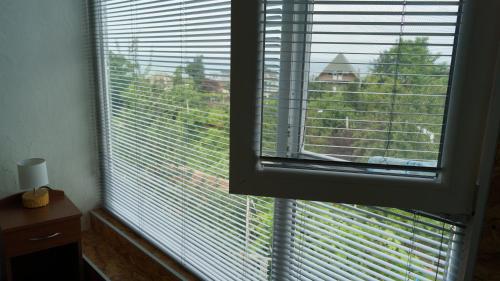 a window with a view of a building at TJ Guest House in Makhinjauri