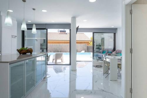 a kitchen with white appliances and a dining room at Apartamentos Rosa de Abril in Teià