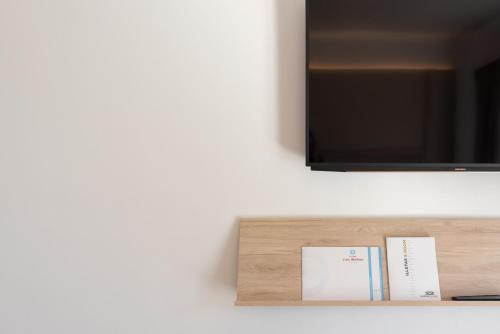 a shelf with a tv on a wall at Hotel ROC Illetas & SPA in Illetas