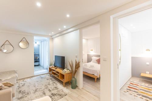 a living room with a bed and a television in a room at Oporto Lovely House in Porto