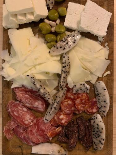 a cutting board with different types of cheese and meats at Villa Melnik SPA Residence with Hot Pool by BookVillaBG in Melnik