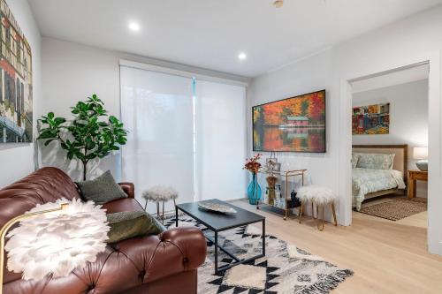 a living room with a leather couch and a bedroom at 15 City View Santa Monica in Los Angeles