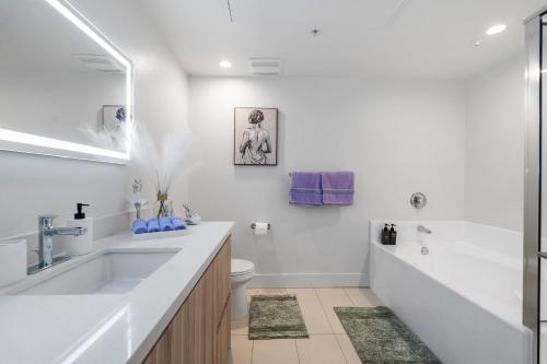 a white bathroom with a sink and a toilet at 15 City View Santa Monica in Los Angeles
