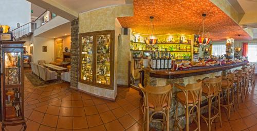 a bar in a restaurant with bar stools at Hotel Hermitage in Portoferraio