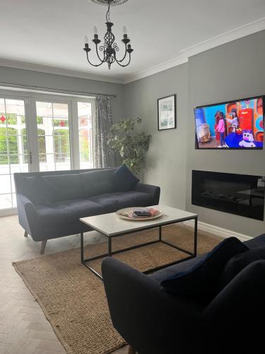 a living room with a couch and a tv at The Nutshell in Southport