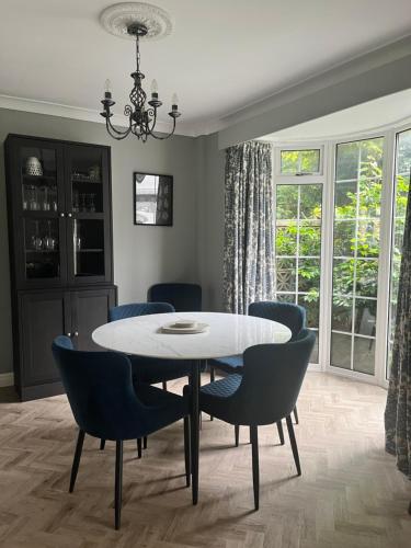 a dining room with a white table and chairs at The Nutshell in Southport