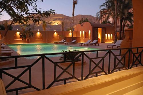 a swimming pool in the middle of a resort at Malkata House - Boutique hotel and restaurant in Luxor