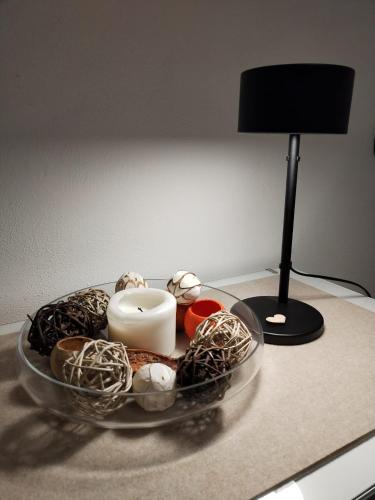 a glass tray with a candle and a lamp on a table at un balcone sul lago in Omegna