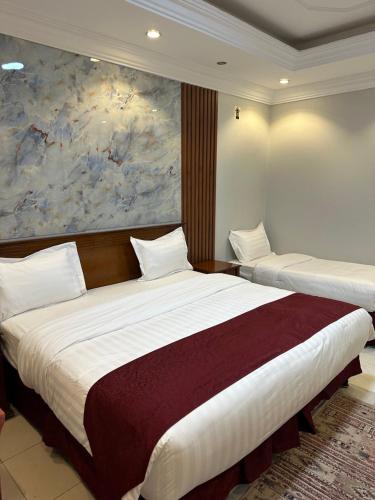 - 2 lits dans une chambre d'hôtel ornée d'une peinture murale dans l'établissement فندق درة المنابر الفندقية, à Médine