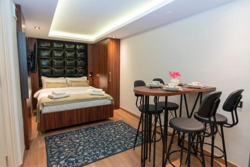 a bedroom with a bed and a table and chairs at THE MUA LUXURY HOMEs in Istanbul