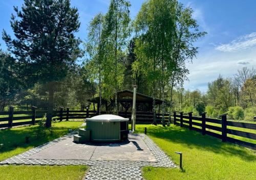 a park with a garbage can and a fence at Zielony Jawornik in Jawornik Stary