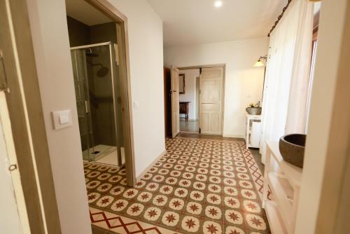 a bathroom with a shower and a tiled floor at Teralba 1 Casa Rural in La Calzada de Oropesa