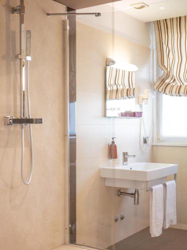 a bathroom with a sink and a shower at San Valentino Hotel in Villa di Serio