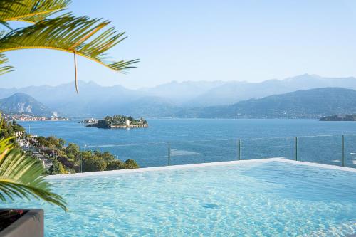 a swimming pool with a view of the water at Hotel La Palma in Stresa