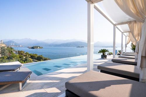 a pool on a house with a view of the water at Hotel La Palma in Stresa