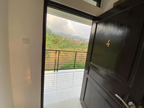 a door with a view of a balcony at Kamar no 4 in Sampal 2