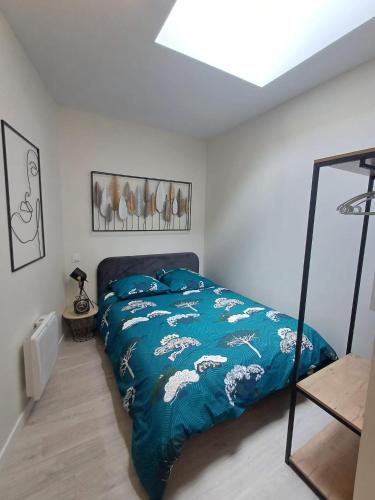 une chambre avec un lit avec une couette bleue dans l'établissement Le studio du canal, 2 pers, wifi, à Agen