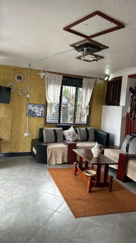 a living room with a couch and a table at sakalaka in Fort Portal