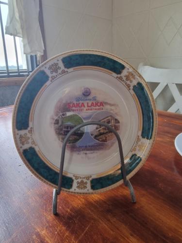 a plate sitting on top of a wooden table at sakalaka in Fort Portal