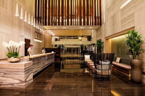 a lobby of a hotel with a bar at Capital Centre Arjaan by Rotana in Abu Dhabi
