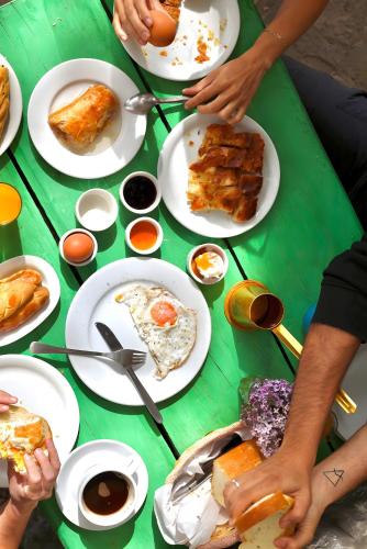 a green table with plates of food on it at Armoloi Traditional - Guest House in Konitsa