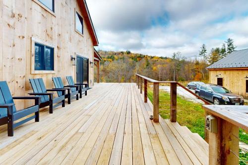 a wooden deck with chairs on top of a house at The Hollow in Plymouth