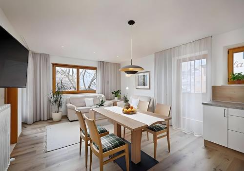 a kitchen and living room with a table and chairs at Wieser in Schenna