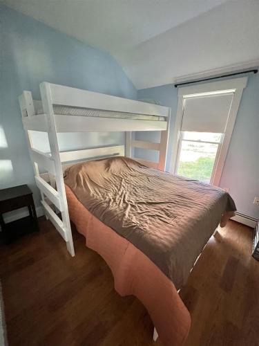 a white bunk bed in a room with a window at SHURIKEN SHORES LIMIT 5 villa in Windham