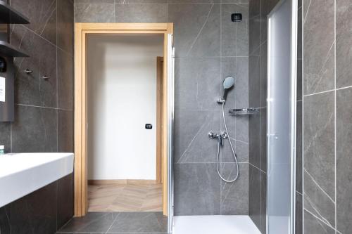 a bathroom with a shower with a glass door at B&B Hotel Passo Tre Croci Cortina in Cortina dʼAmpezzo