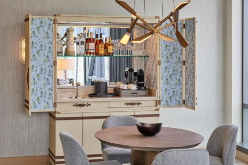 a dining room with a table and a kitchen at The Ritz-Carlton, Portland in Portland