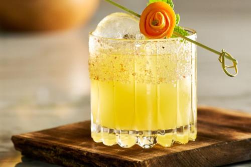 a drink with an orange rose in a glass at The Ritz-Carlton, Portland in Portland
