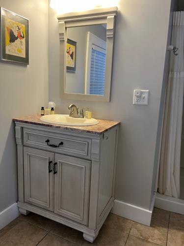 a bathroom with a sink and a mirror at Abalonia Inn in Ogunquit