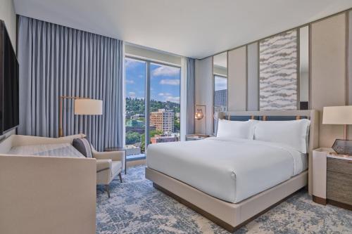 a bedroom with a bed and a large window at The Ritz-Carlton, Portland in Portland