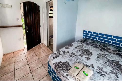 a bedroom with a bed in a room with a door at Pousada Ponta da Ilha, Ilha Grande, Angra dos Reis in Angra dos Reis
