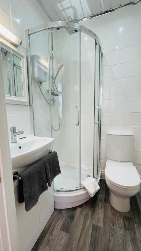 a bathroom with a shower and a toilet and a sink at Double Room with Private Bathroom Partial Tower view 16 Havelock Street - 5 in Blackpool