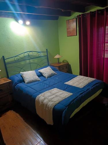 a bedroom with a blue bed with a blue blanket at Casa Rural de Abuelo in Garafía