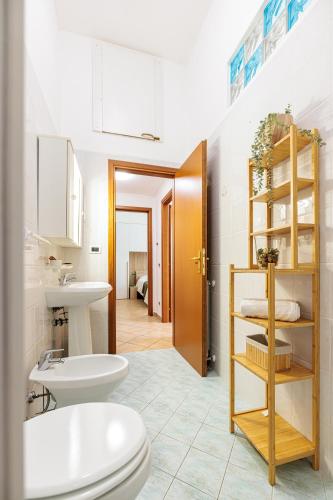 a bathroom with a toilet and a sink at Borgo View - con posto auto privato incluso in Livorno
