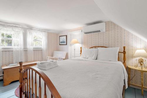a bedroom with a large white bed and a desk at On the Chatham Loop - 1 Min to the Beach in Chatham