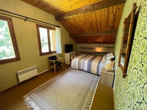 Un dormitorio con dos camas y techo de madera. en La Lézardière - Chalet spacieux près des pistes, en La Toussuire