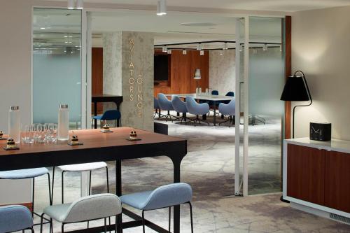 a dining room with a table and chairs at London Heathrow Marriott Hotel in Hillingdon
