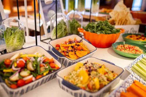 a table topped with bowls of different types of vegetables at London Heathrow Marriott Hotel in Hillingdon