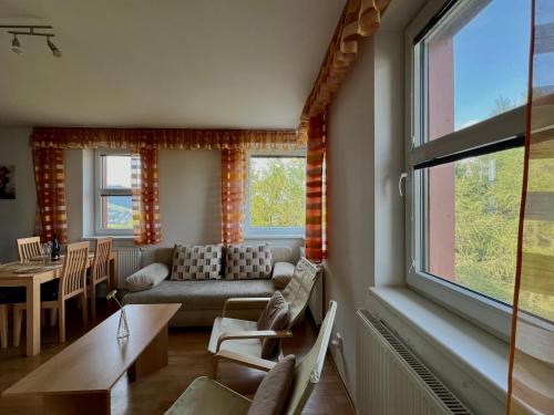 a living room with a couch and a table at Ski Apartmán Salomon in Loučná pod Klínovcem