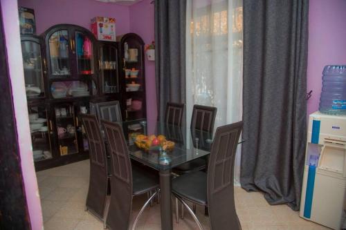 a dining room with a glass table and chairs at 3 Bedroom Appartment with Beautiful view of Kilimanjaro Mountain in Moshi