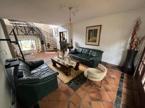 a living room with a couch and a table at DAPA CASA CAMPESTRE CON PISCINA y JACUZZI in Dapa