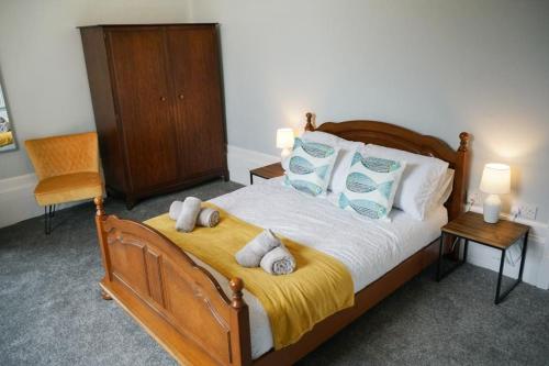 a bedroom with a bed with blue and white pillows at Home in Dunoon Argyll and Bute in Dunoon