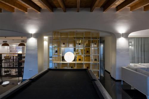 a pool table in the middle of a room at Hotel San Teodoro in San Teodoro