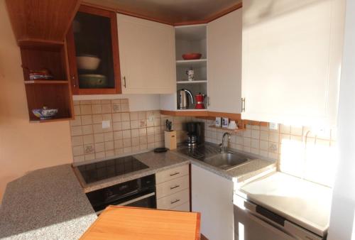 a kitchen with white cabinets and a sink at Apartment Cinema in Savudrija