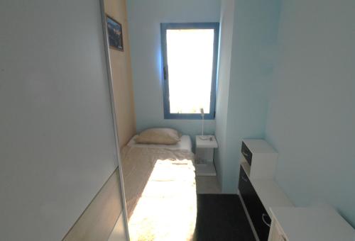 a mirror in a small room with a bed and a window at Apartment Cinema in Savudrija