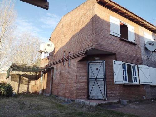 a brick house with a door on the side of it at Casita del Mar in Las Toninas