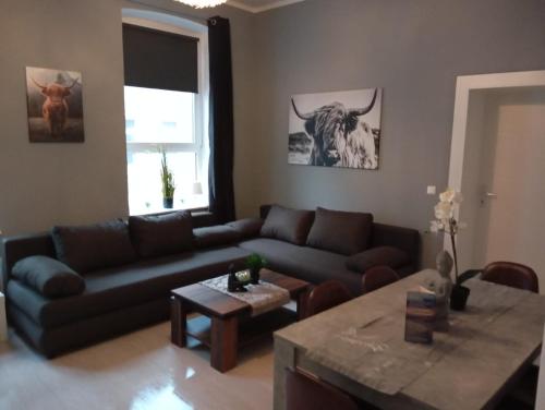 a living room with a couch and a table at Stadtnah an der Förde 75 01 R in Flensburg